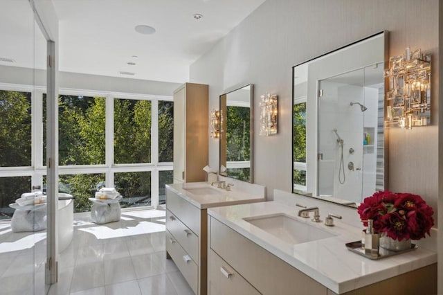 bathroom with tile patterned floors, a shower with shower door, and vanity