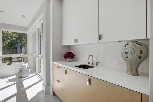 interior space featuring light stone countertops and sink