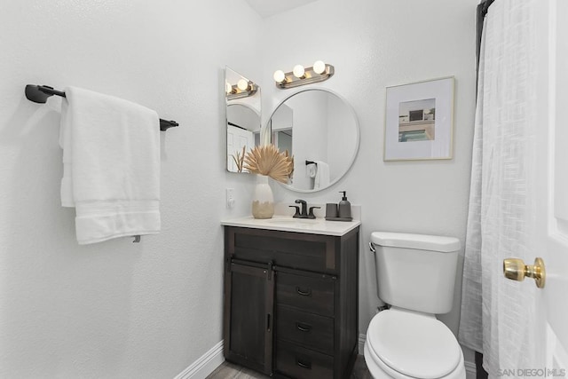 bathroom featuring toilet and vanity