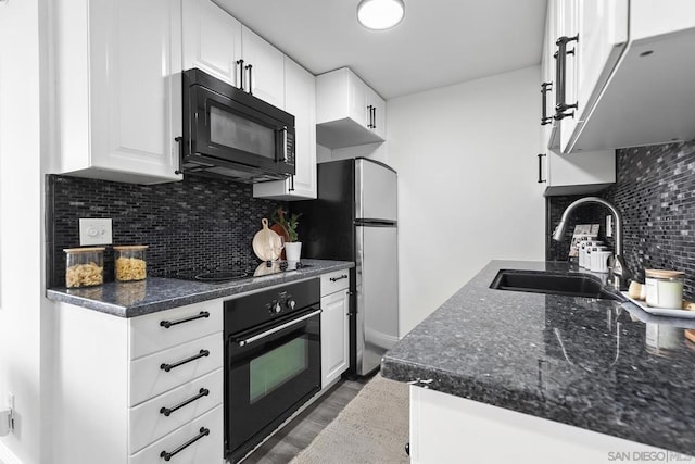 kitchen with sink, backsplash, white cabinets, and black appliances