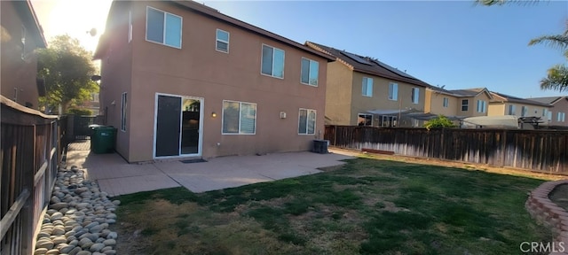 back of house featuring a patio area and a yard