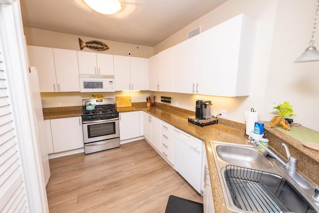 kitchen with white cabinetry, light hardwood / wood-style floors, decorative light fixtures, white appliances, and sink