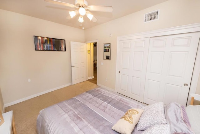 bedroom with ceiling fan, a closet, and light carpet