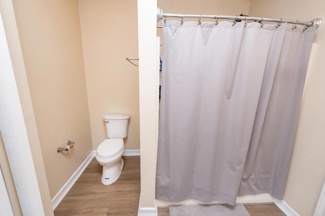 bathroom with wood-type flooring and toilet