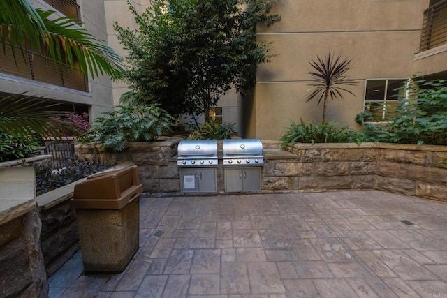 view of patio featuring an outdoor kitchen and a grill