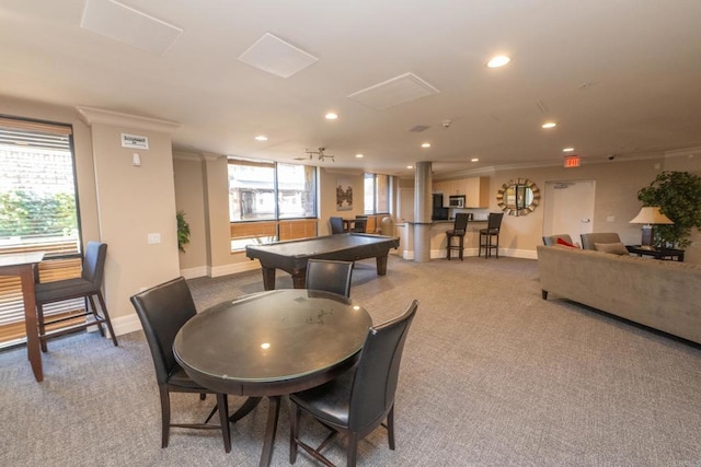 rec room featuring bar, crown molding, and light colored carpet