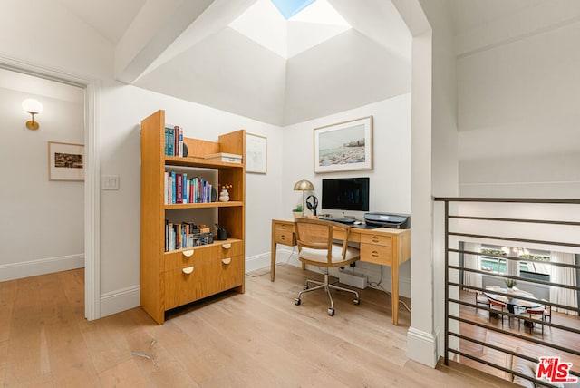 office featuring lofted ceiling and light hardwood / wood-style floors