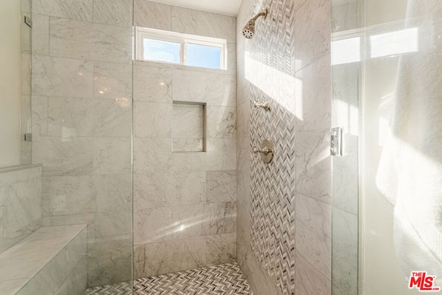 bathroom with tiled shower