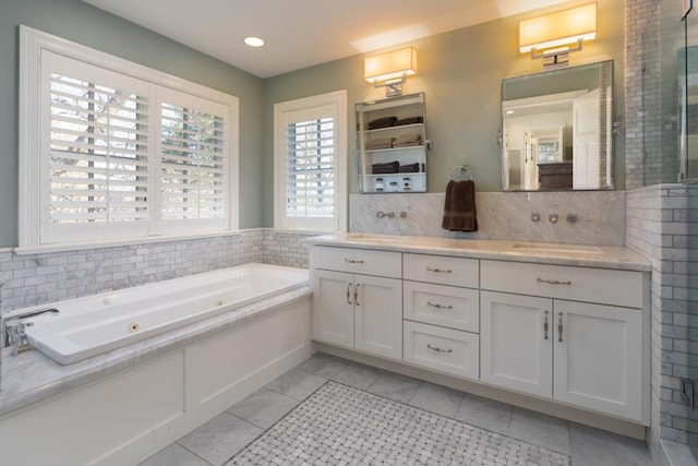 bathroom featuring vanity and a tub to relax in