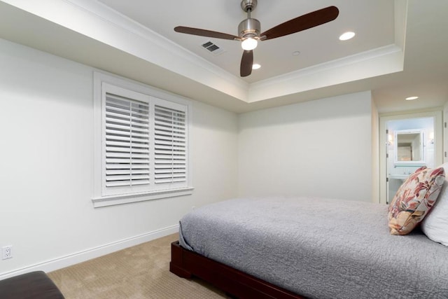 bedroom with carpet floors, ornamental molding, a raised ceiling, and ceiling fan