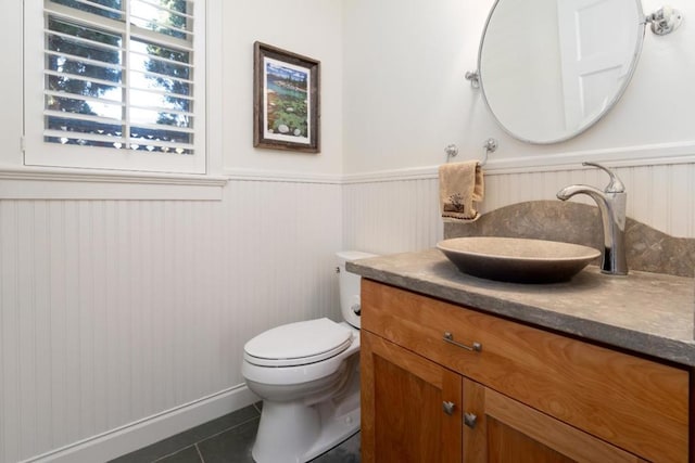 bathroom featuring tile patterned floors, toilet, and vanity