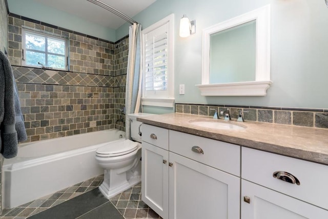 full bathroom with tiled shower / bath, vanity, toilet, and tile patterned floors