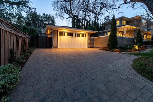 view of garage at dusk