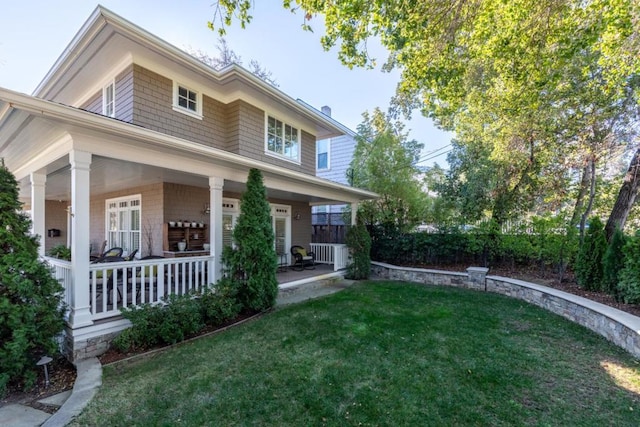 view of front facade with a front yard and a porch