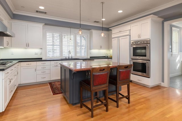 kitchen featuring white cabinetry, sink, and appliances with stainless steel finishes