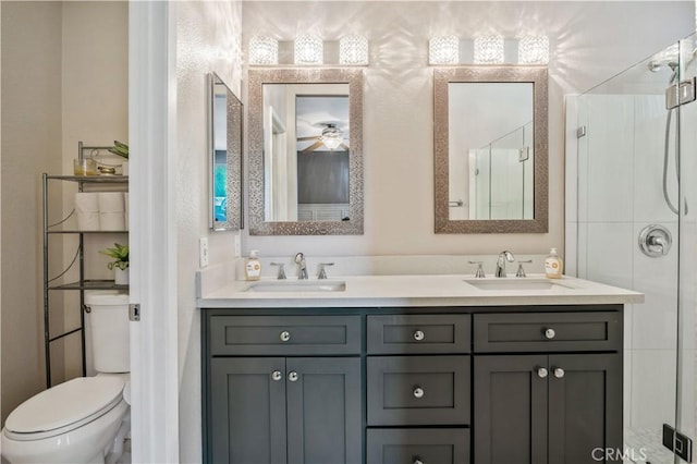 bathroom with toilet, vanity, and ceiling fan