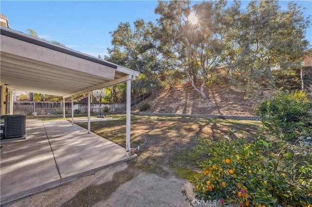 view of yard with central AC unit and a patio