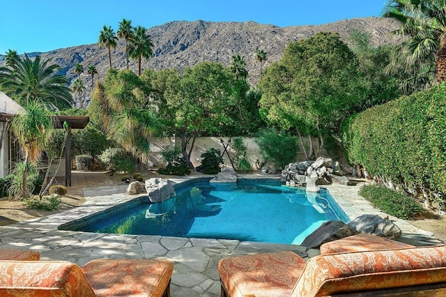 view of swimming pool with a mountain view