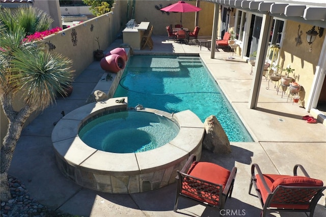 view of swimming pool with an in ground hot tub and a patio area