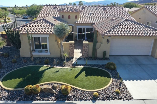 mediterranean / spanish home with a front lawn and a garage