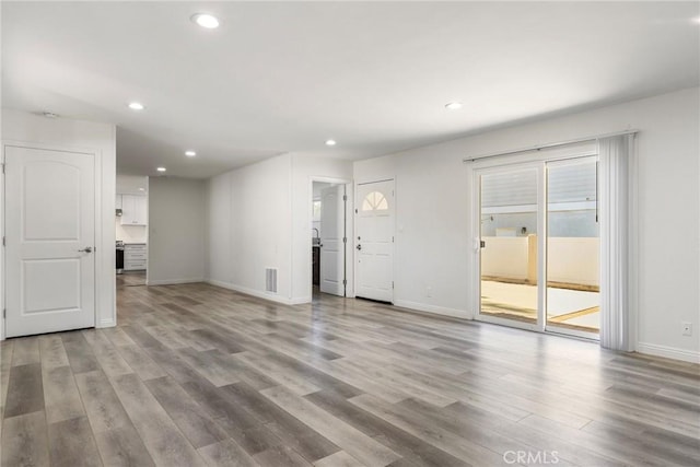 unfurnished living room featuring light wood-type flooring