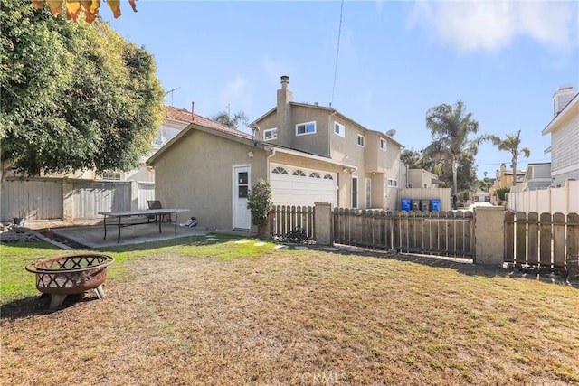 back of property featuring a lawn and a patio