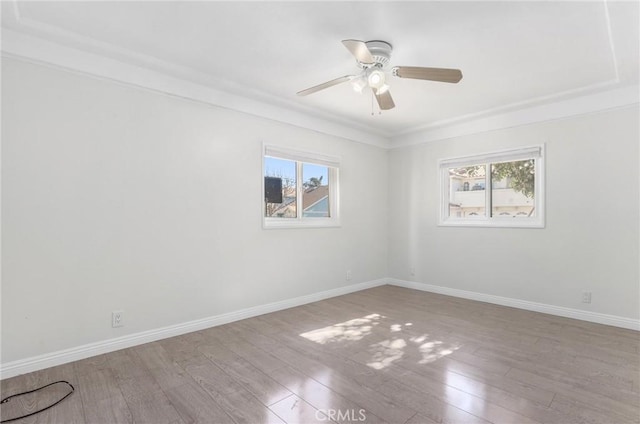 unfurnished room with ceiling fan, a wealth of natural light, crown molding, and light hardwood / wood-style flooring