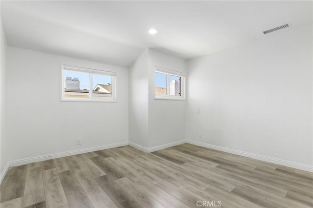 spare room featuring light hardwood / wood-style floors