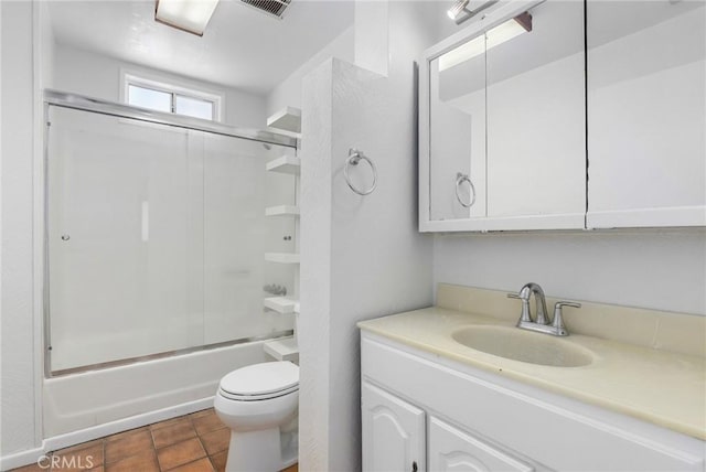 full bathroom with toilet, enclosed tub / shower combo, tile patterned flooring, and vanity