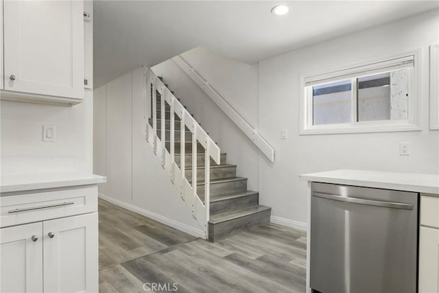 stairs featuring hardwood / wood-style floors