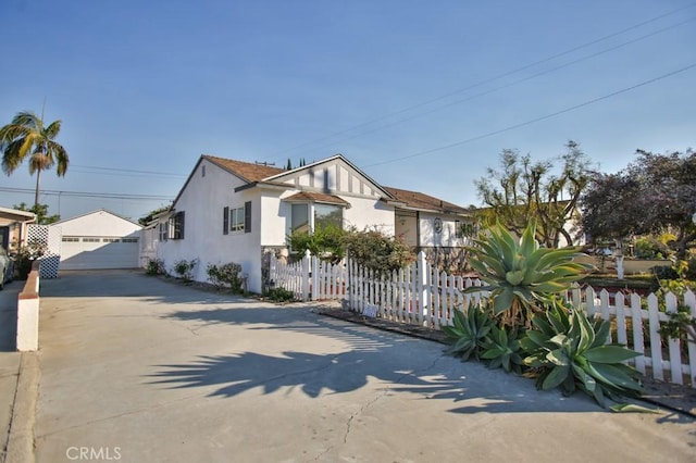 view of front facade featuring a garage and an outdoor structure