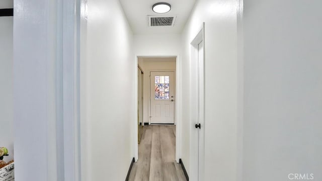 hall featuring visible vents and light wood-type flooring