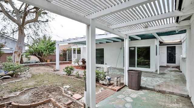 view of patio / terrace featuring a pergola and fence