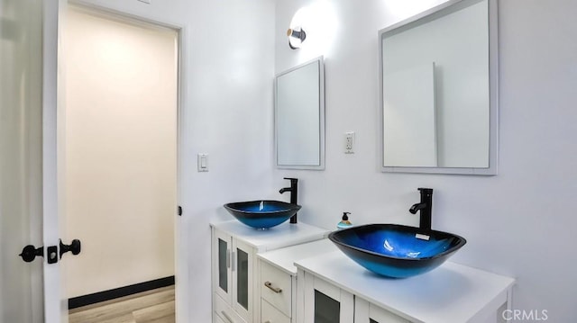 bathroom with vanity and wood finished floors