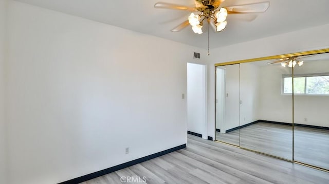 unfurnished bedroom with visible vents, baseboards, light wood-style flooring, a closet, and a ceiling fan