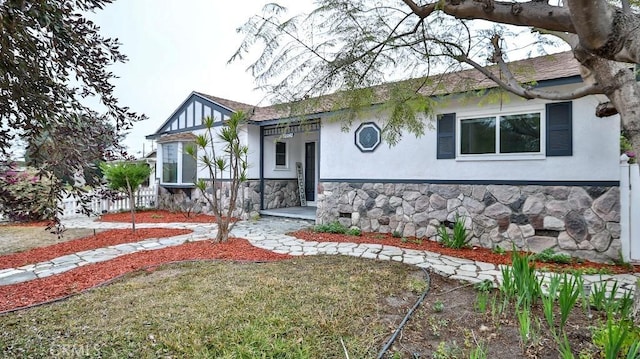 view of front facade with stucco siding and stone siding