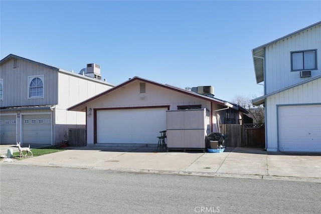 view of front of property featuring a garage and central air condition unit