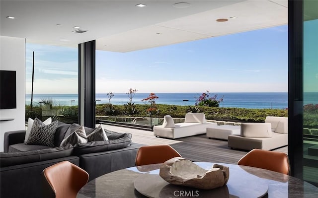 interior space with a water view and outdoor lounge area