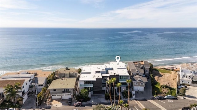 drone / aerial view featuring a water view and a beach view