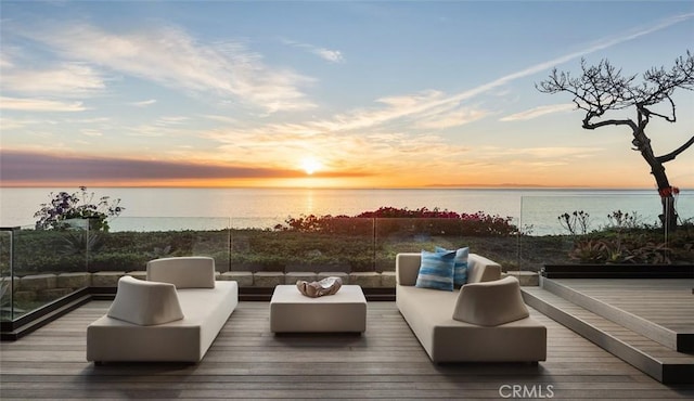 deck at dusk featuring a water view and an outdoor hangout area