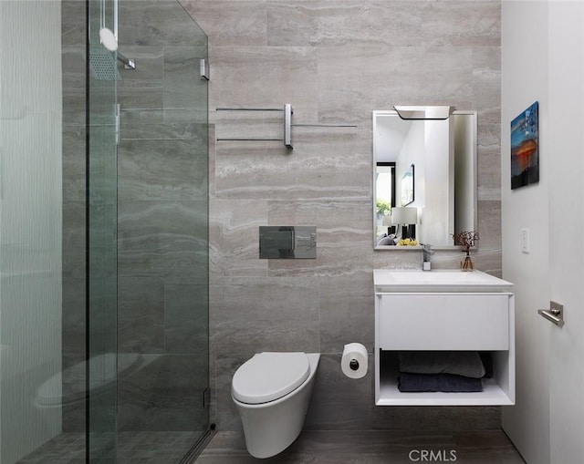 bathroom with an enclosed shower, vanity, and toilet