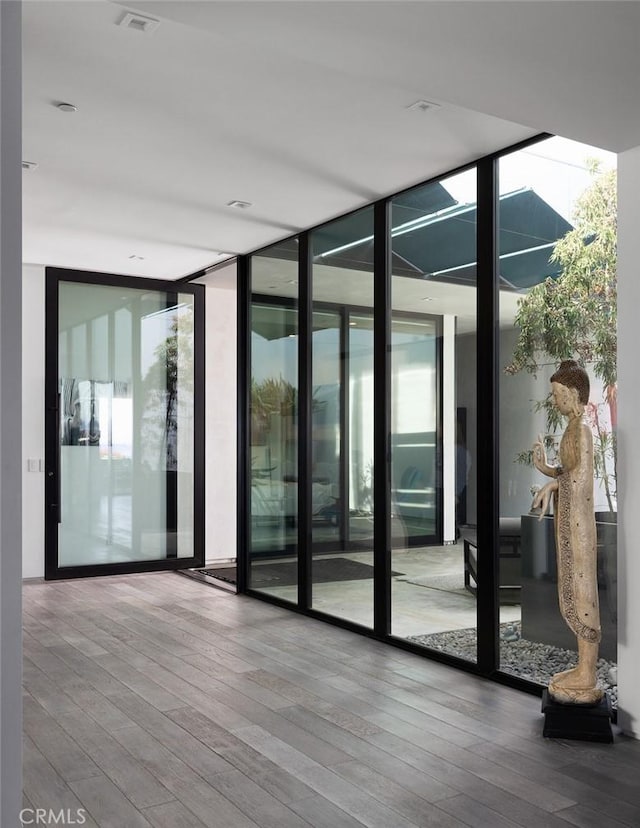 entryway featuring wood-type flooring and expansive windows