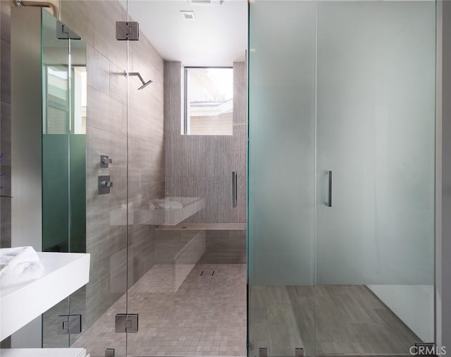 bathroom with a shower with door