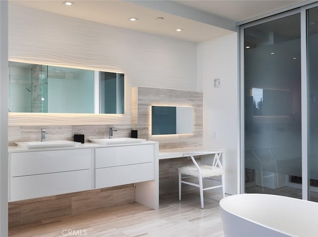 bathroom featuring independent shower and bath and vanity