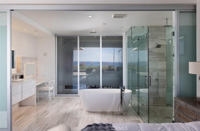 bathroom featuring independent shower and bath, vanity, and floor to ceiling windows