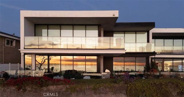 view of back house at dusk