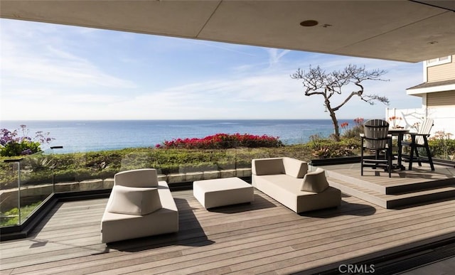 wooden terrace featuring an outdoor living space and a water view