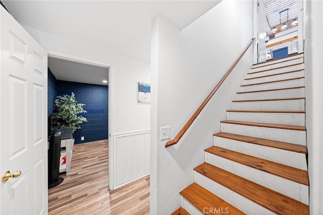 stairs featuring wood-type flooring