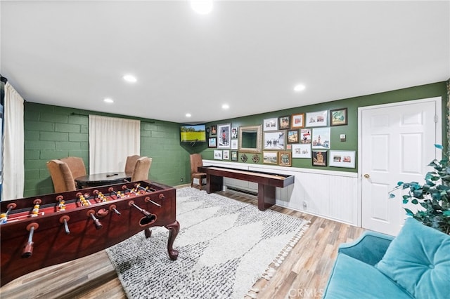 game room with wood-type flooring