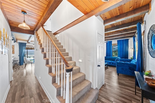 stairs featuring wood ceiling, beamed ceiling, and hardwood / wood-style flooring